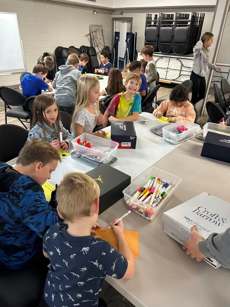 TCIW Kids working on decorating boxes for the shoe box drive